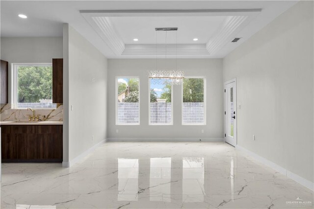 1013 N Buxton Ave, Edinburg, TX 78541 - unfurnished living room with light marble finish flooring, a sink, a chandelier, plenty of natural light, and recessed lighting