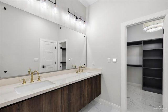 bathroom featuring marble look tile flooring, baseboards, and double vanity