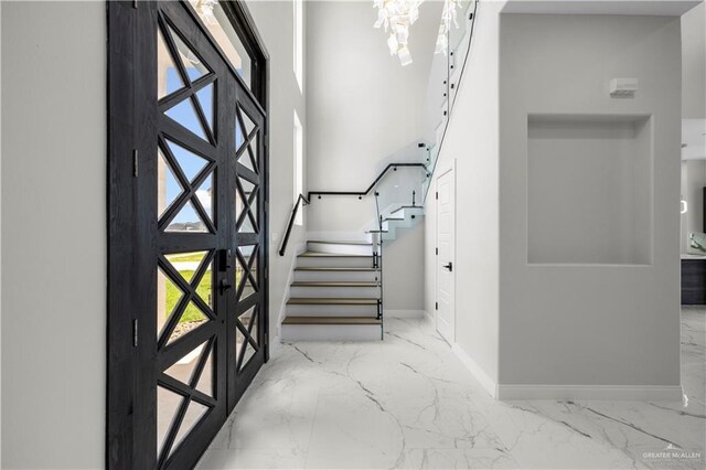 1013 N Buxton Ave, Edinburg, TX 78541 - foyer entrance featuring marble tiled flooring, baseboards, and stairway