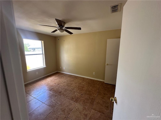 tiled empty room with ceiling fan