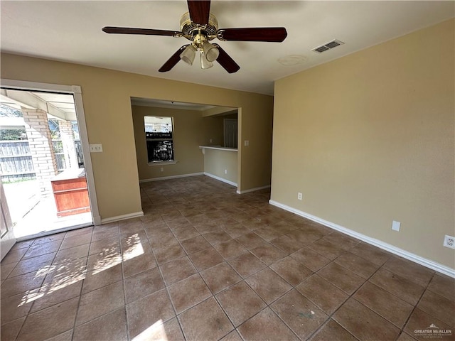 spare room featuring tile patterned flooring and ceiling fan