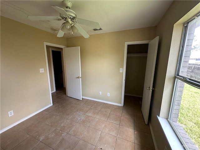 unfurnished bedroom with ceiling fan, light tile patterned flooring, and a closet