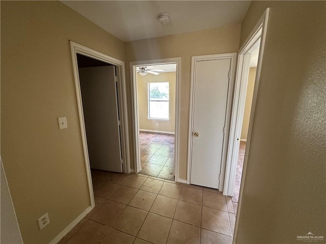 corridor with light tile patterned floors