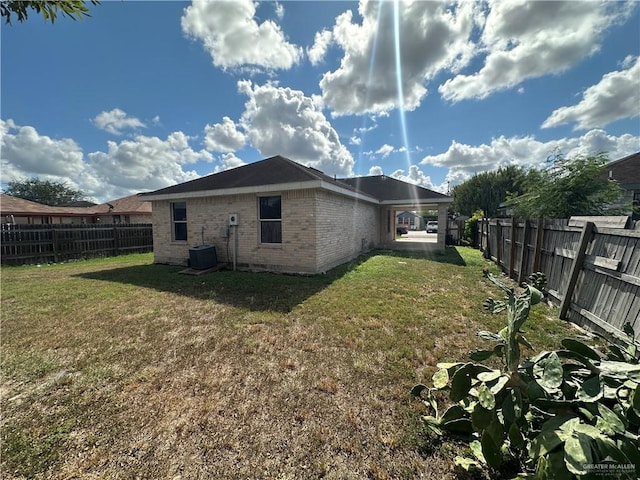 view of property exterior with central AC unit and a yard