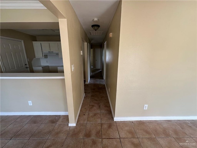 corridor featuring dark tile patterned floors