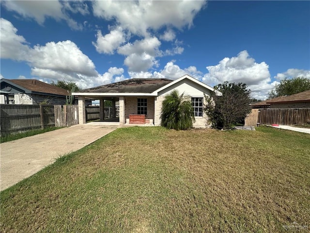 view of front facade with a front yard and a carport