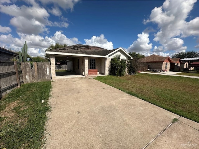 ranch-style home featuring a front lawn and a carport