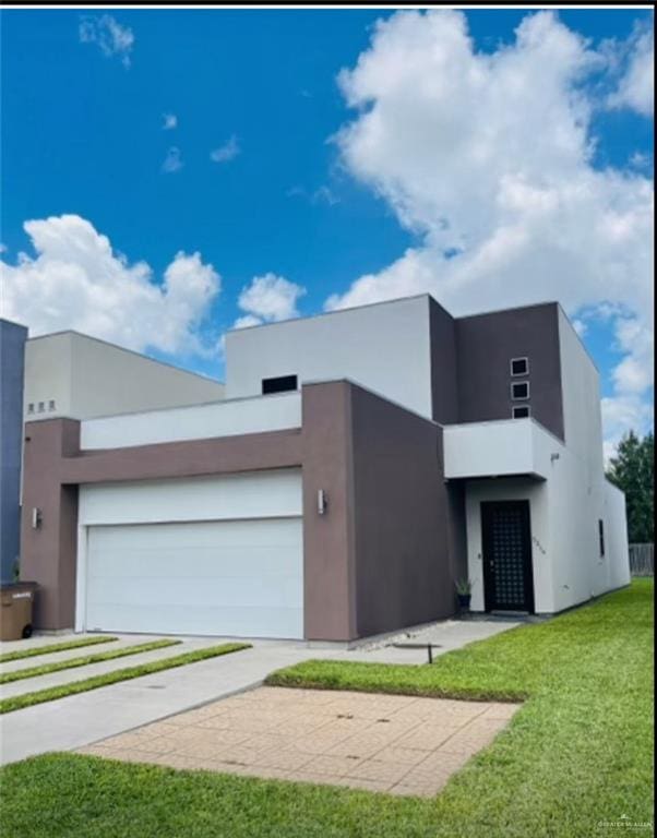 contemporary home with a front yard and a garage