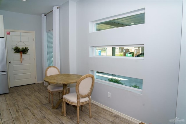 dining space with light hardwood / wood-style floors