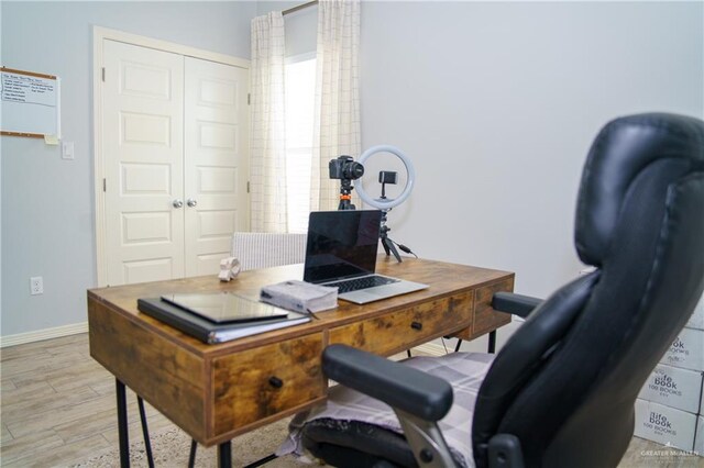 office area with light hardwood / wood-style floors