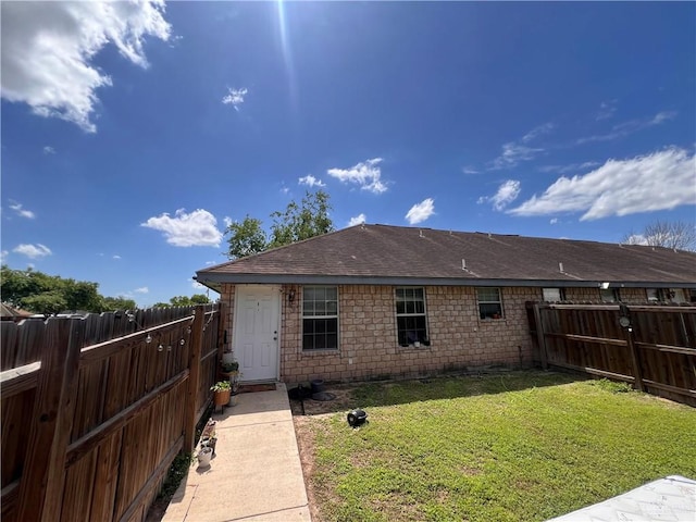 rear view of house with a lawn