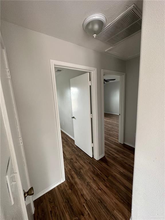 corridor featuring dark hardwood / wood-style flooring