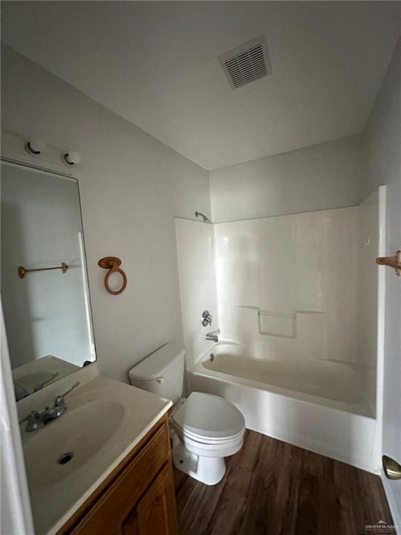 full bathroom featuring vanity, hardwood / wood-style flooring, toilet, and tub / shower combination