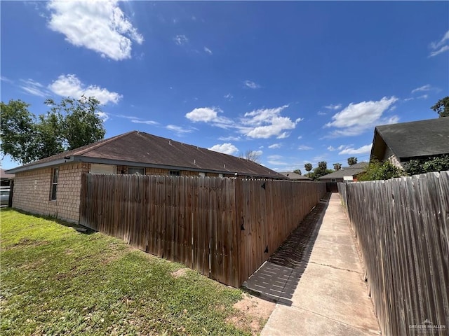 view of side of property featuring a yard