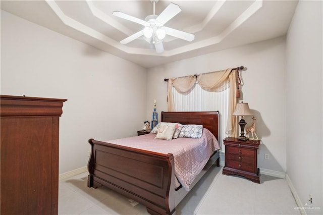 2005 E 28th St, Mission, TX 78574 - bedroom featuring a tray ceiling, light tile patterned floors, and a ceiling fan