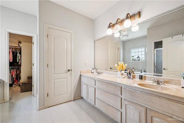 2005 E 28th St, Mission, TX 78574 - full bathroom with tile patterned flooring, a stall shower, double vanity, and a walk in closet