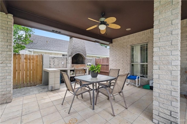 2005 E 28th St, Mission, TX 78574 - view of patio / terrace with exterior fireplace, a ceiling fan, and outdoor dining area