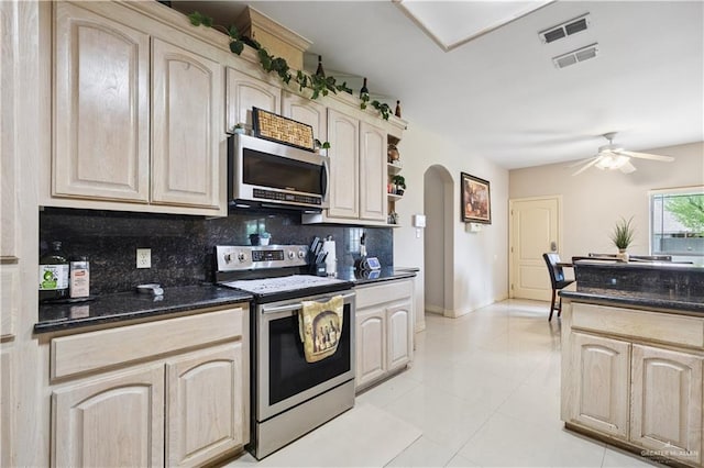 2005 E 28th St, Mission, TX 78574 - kitchen featuring appliances with stainless steel finishes, arched walkways, light brown cabinets, backsplash, and light tile patterned floors