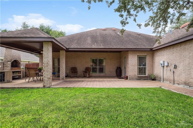 2005 E 28th St, Mission, TX 78574 - rear view of property with roof with shingles, a patio, and a fireplace