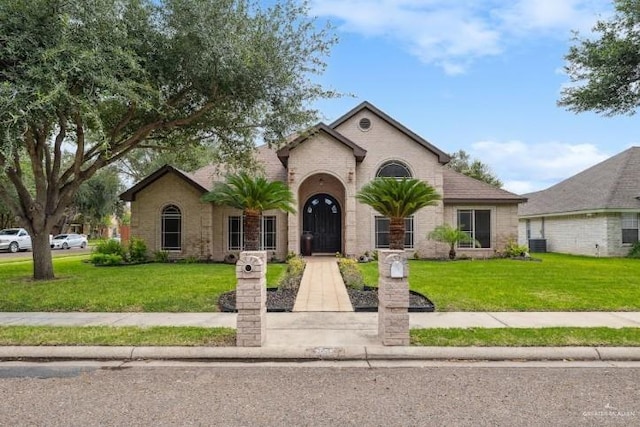 2005 E 28th St, Mission, TX 78574 - view of front of home featuring a front lawn and brick siding