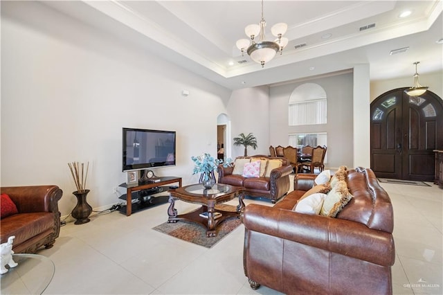 2005 E 28th St, Mission, TX 78574 - living area featuring arched walkways, a tray ceiling, tile patterned floors, ornamental molding, and recessed lighting