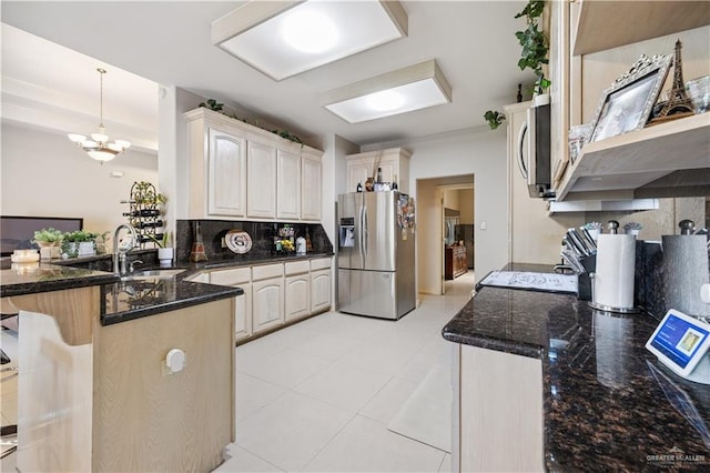 2005 E 28th St, Mission, TX 78574 - kitchen featuring appliances with stainless steel finishes, a peninsula, tasteful backsplash, dark stone countertops, and light tile patterned floors