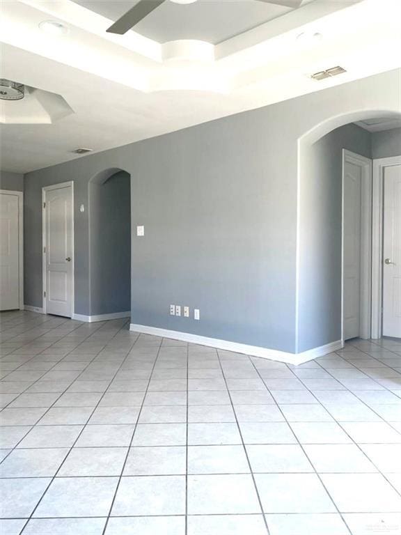 1706 Phoenix St, Edinburg, TX 78541 - spare room featuring a raised ceiling, visible vents, light tile patterned floors, arched walkways, and baseboards