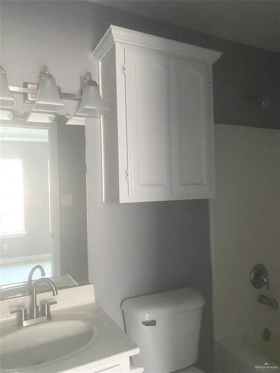 1706 Phoenix St, Edinburg, TX 78541 - bathroom with tub / shower combination, toilet, and vanity