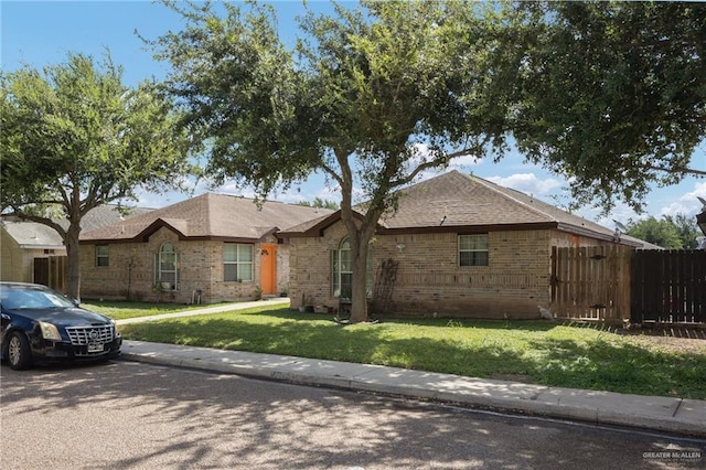 1706 Phoenix St, Edinburg, TX 78541 - single story home with brick siding, fence, and a front yard
