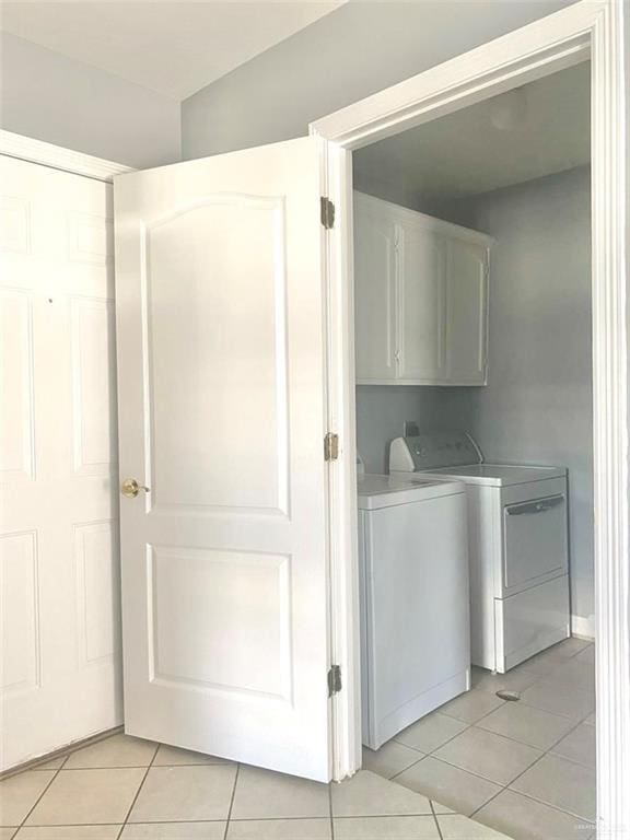 1706 Phoenix St, Edinburg, TX 78541 - clothes washing area with washing machine and dryer, cabinet space, and light tile patterned floors