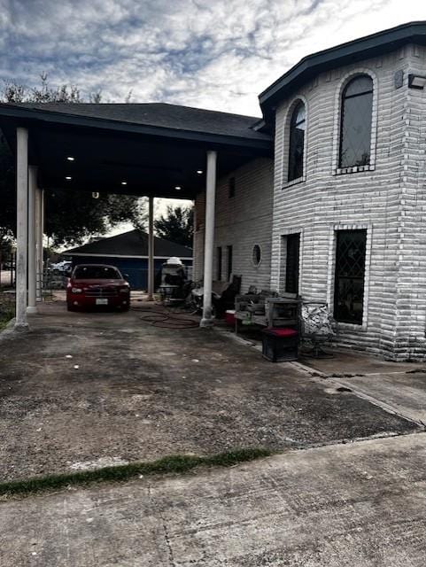 view of vehicle parking with a carport