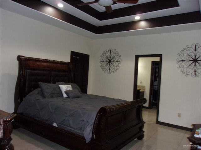 bedroom featuring a raised ceiling and ceiling fan