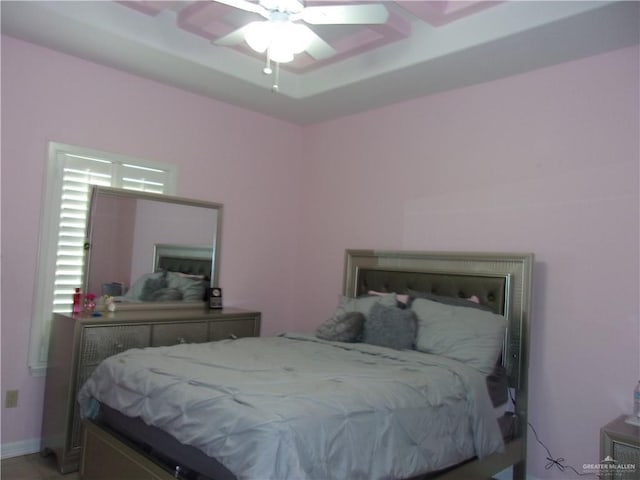 bedroom featuring a tray ceiling and ceiling fan