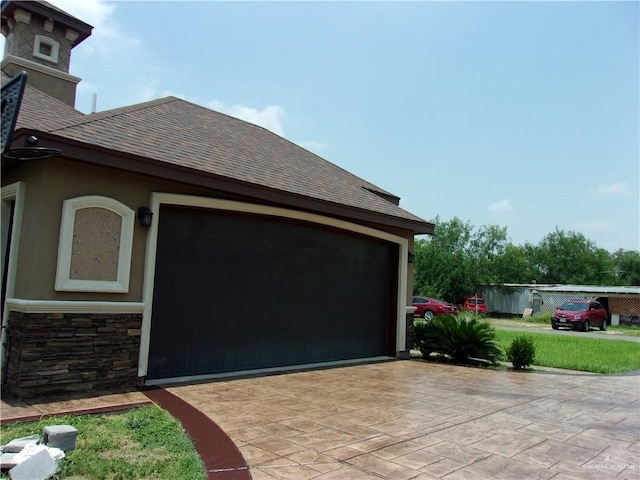 view of side of home featuring a garage