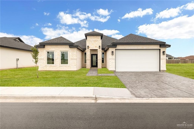 prairie-style house with a garage and a front lawn