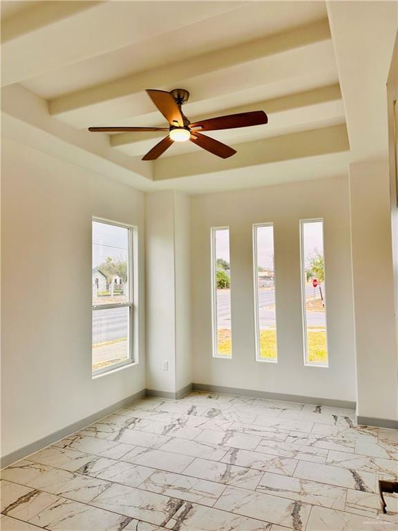 spare room featuring beamed ceiling and ceiling fan