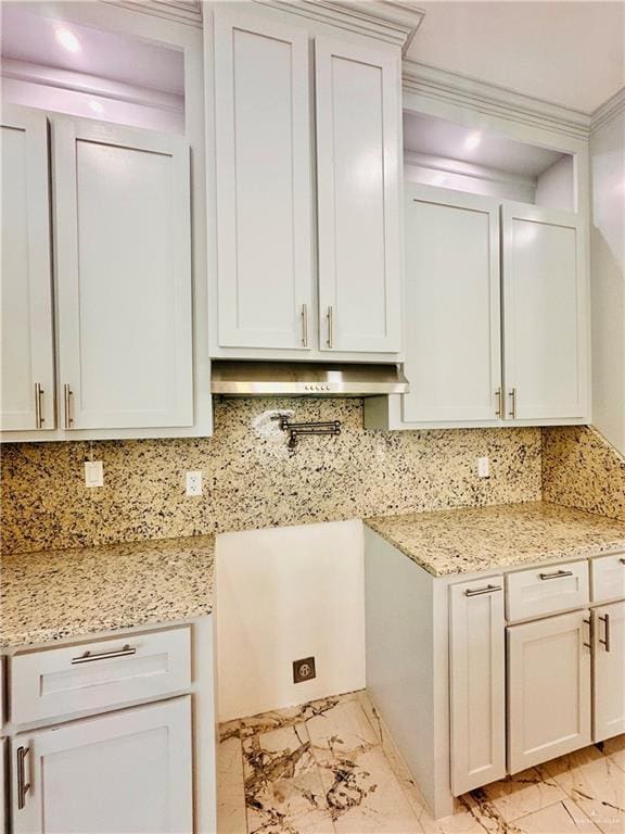 kitchen featuring decorative backsplash, white cabinetry, ornamental molding, and light stone counters