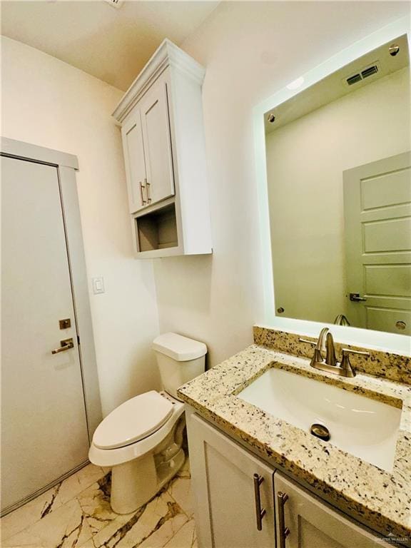 bathroom with vanity and toilet