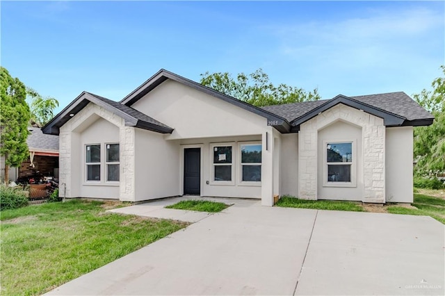 2005 Hacienda Cir, Harlingen, TX 78552 - ranch-style house featuring roof with shingles, a front lawn, stucco siding, and stone siding