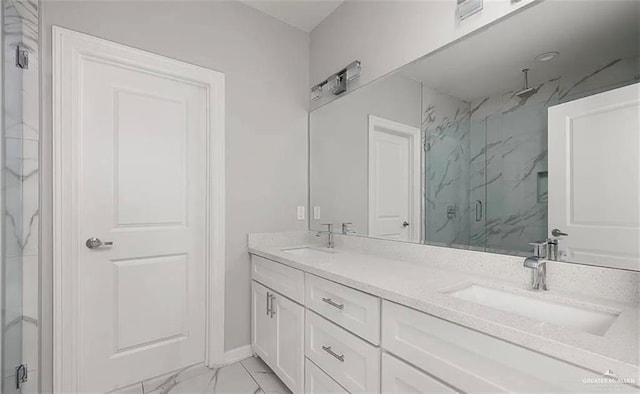 full bathroom with double vanity, marble finish floor, a sink, and a marble finish shower