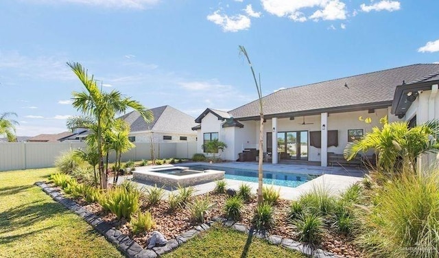 view of pool with an in ground hot tub, a yard, a patio, and ceiling fan