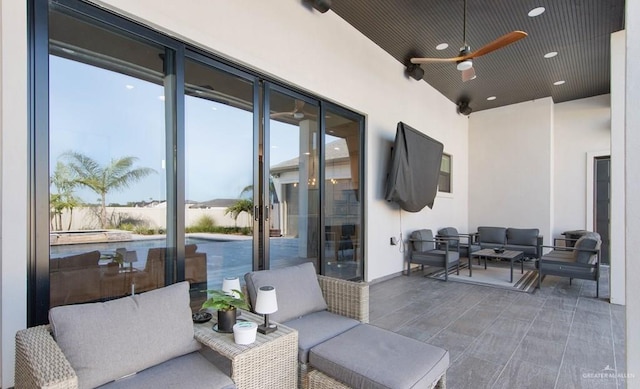 view of patio with an outdoor living space and ceiling fan