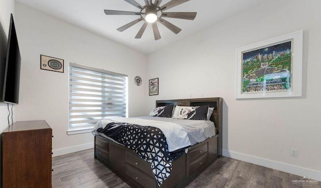 bedroom featuring ceiling fan and dark wood-type flooring