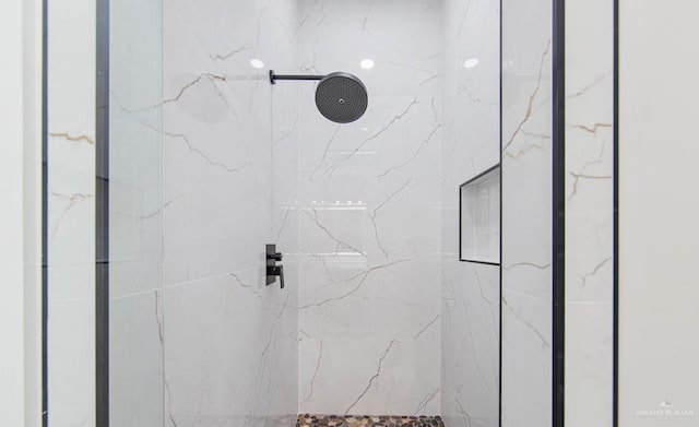 bathroom with a tile shower