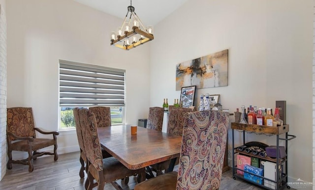 dining room featuring hardwood / wood-style floors and a chandelier