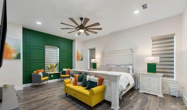 bedroom with ceiling fan and dark hardwood / wood-style flooring