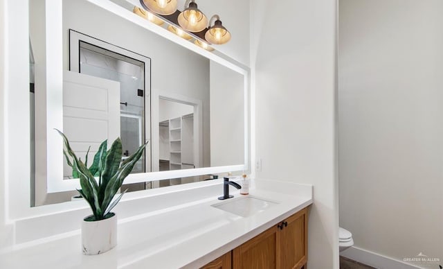 bathroom featuring vanity and toilet