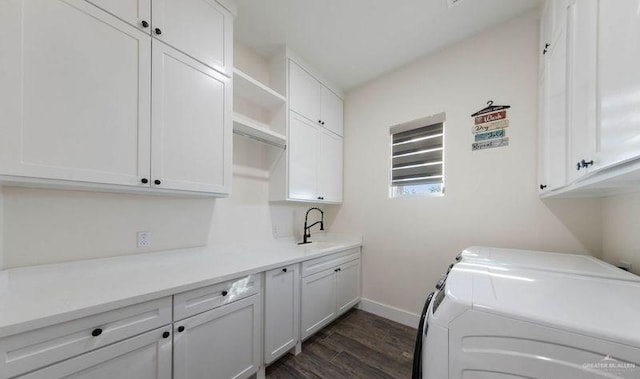 clothes washing area featuring separate washer and dryer, sink, cabinets, and dark hardwood / wood-style floors