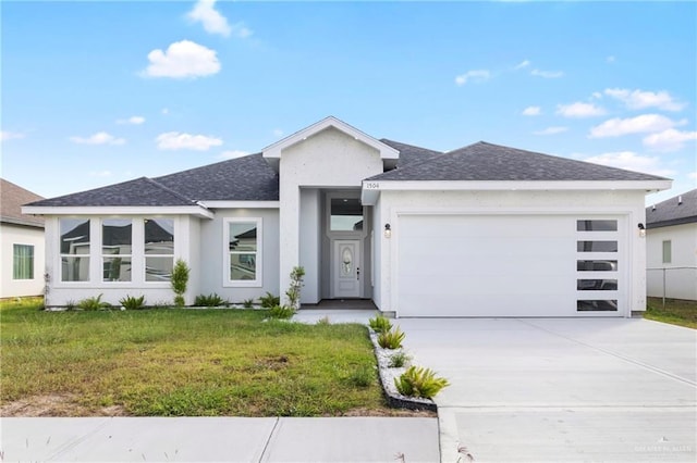 view of front of home with a garage and a front lawn