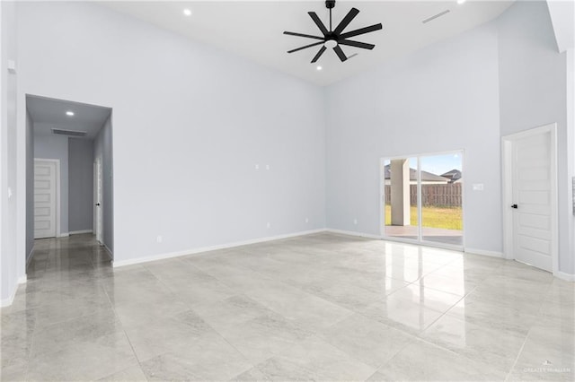 spare room with ceiling fan and a high ceiling